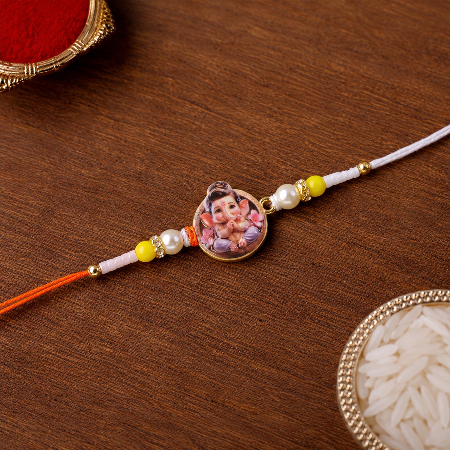 Ganesh Ji Designer Rakhi with yellow beads close-up
