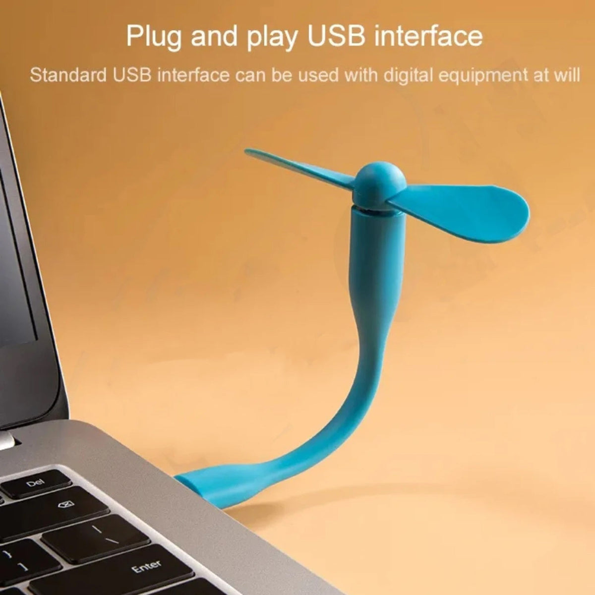 A blue flexible USB fan is plugged into a silver laptop on a brown surface, with text about its interface.