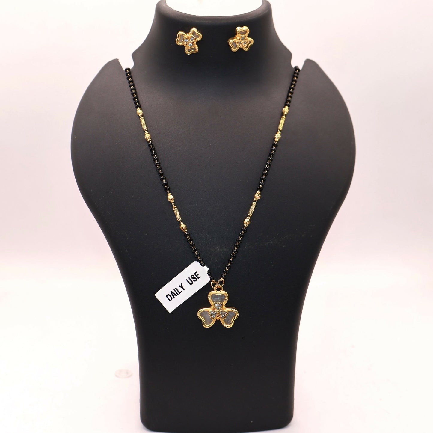 Elegant mangalsutra necklace featuring black beads and gold-plated accents