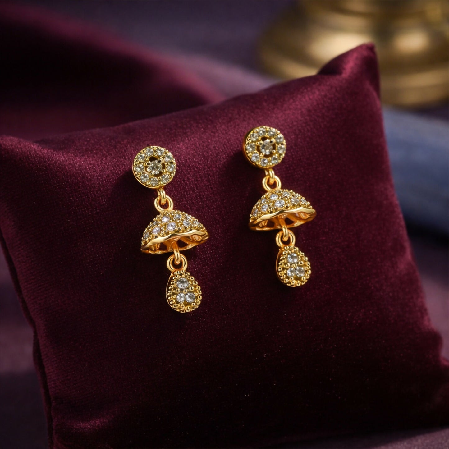Gold-tone floral dome drop earrings with sparkling crystal studs front view