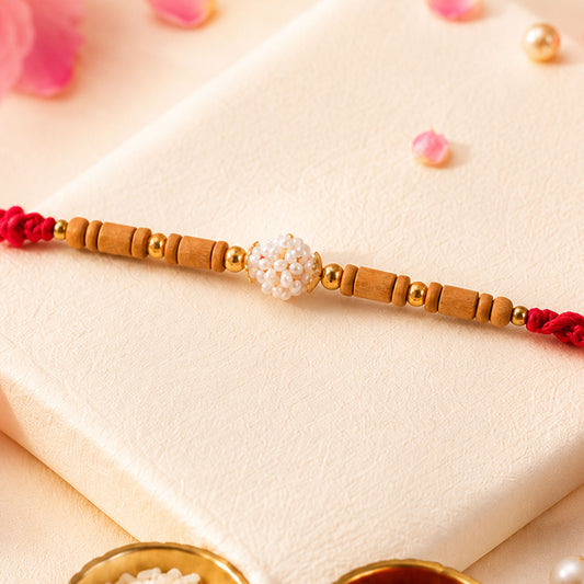 Close-up of stone studded designer rakhi with traditional beads and festive finish.