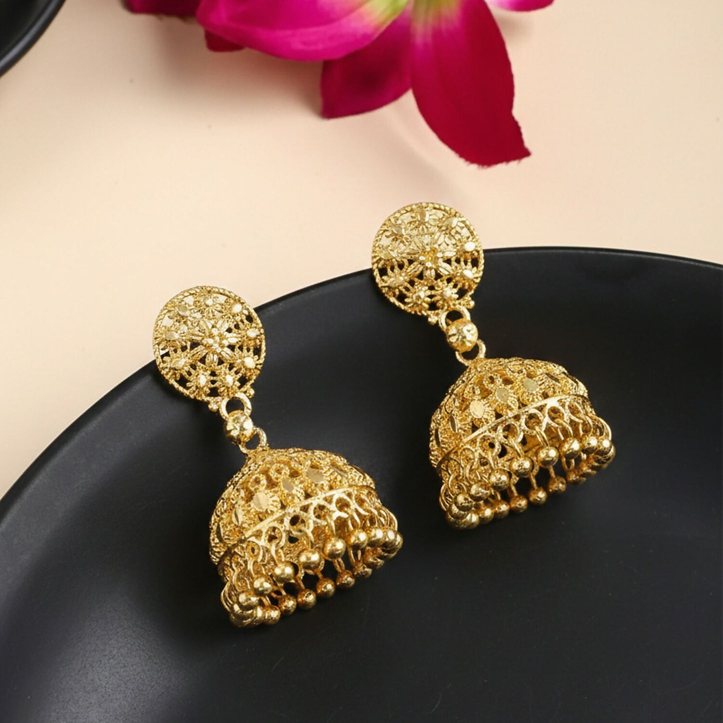 Gold plated jhumka earrings with detailed circular stud and dome shape