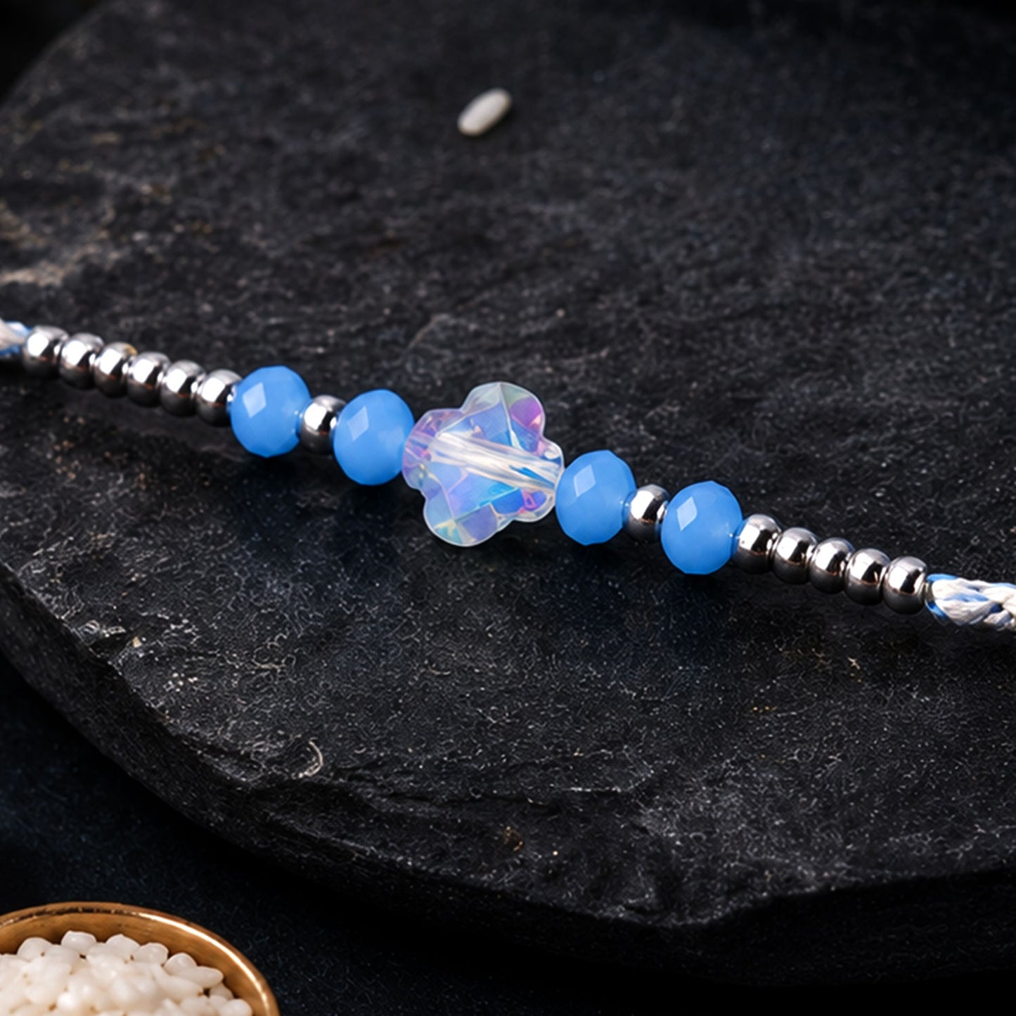 Blue Crystal Bead Rakhi with Round Stone Centre, Silver Highlights and Red Thread