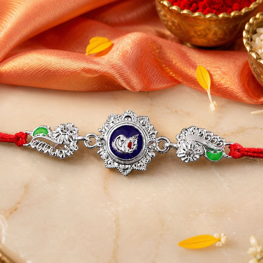 A silver charm with a blue center and a white swan design is flanked by two smaller silver and green charms, all on a red