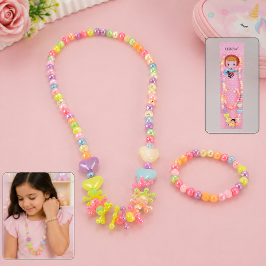 A young girl models a colorful beaded necklace and bracelet set, with the set also displayed on a pink surface next to its