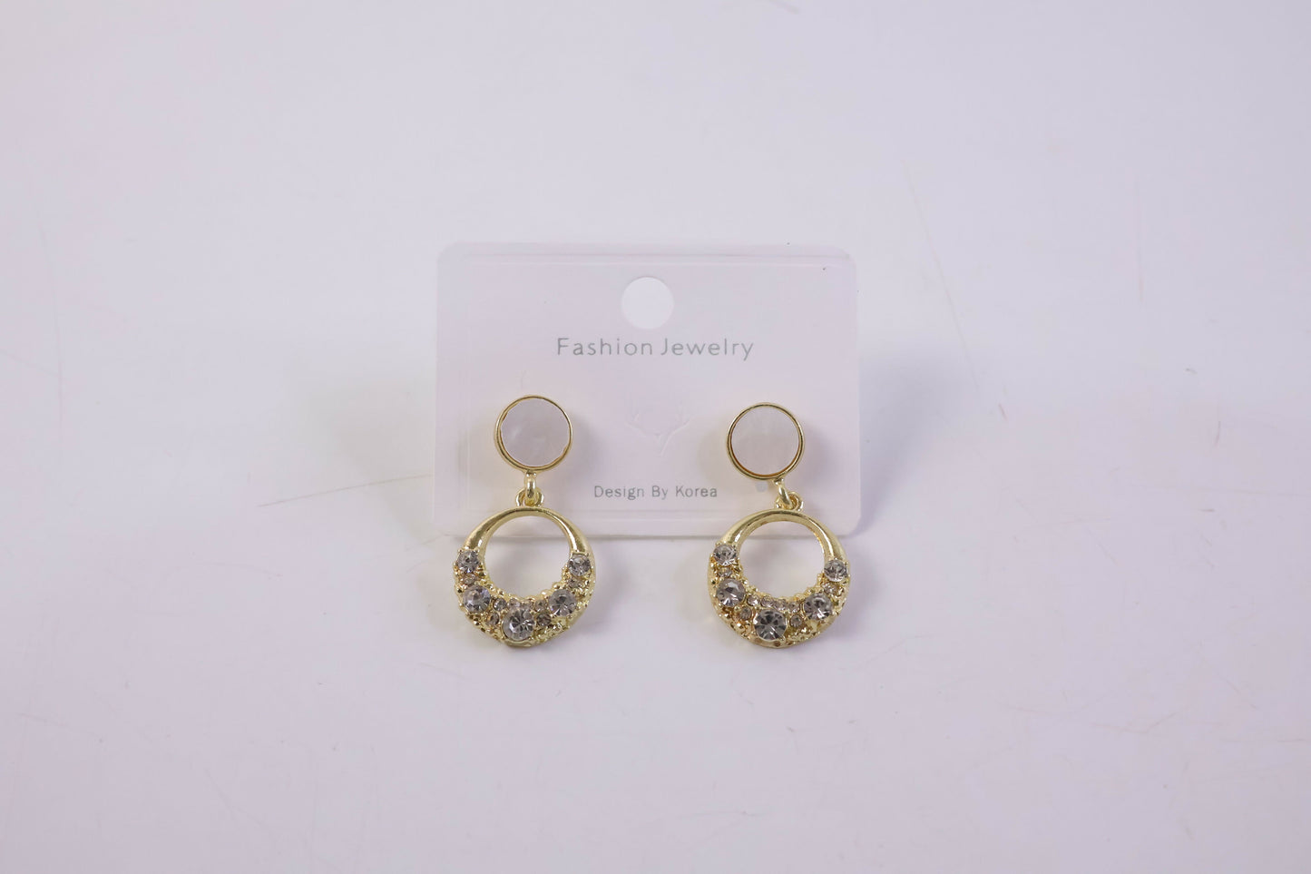 Stylish gold round crystal drop earrings with pearl top in natural light