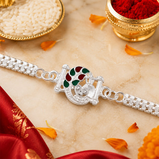Silver Finish Rakhi with red and green enamel detailing, displayed elegantly.