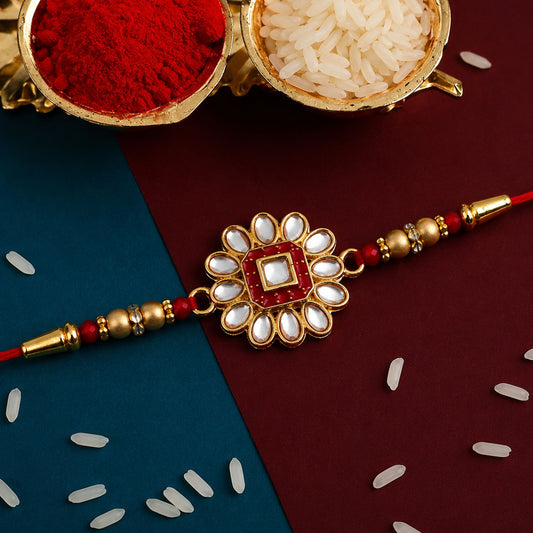 Close-up of a Traditional Rakhi with intricate flower design, sparkling stones, and delicate beads.