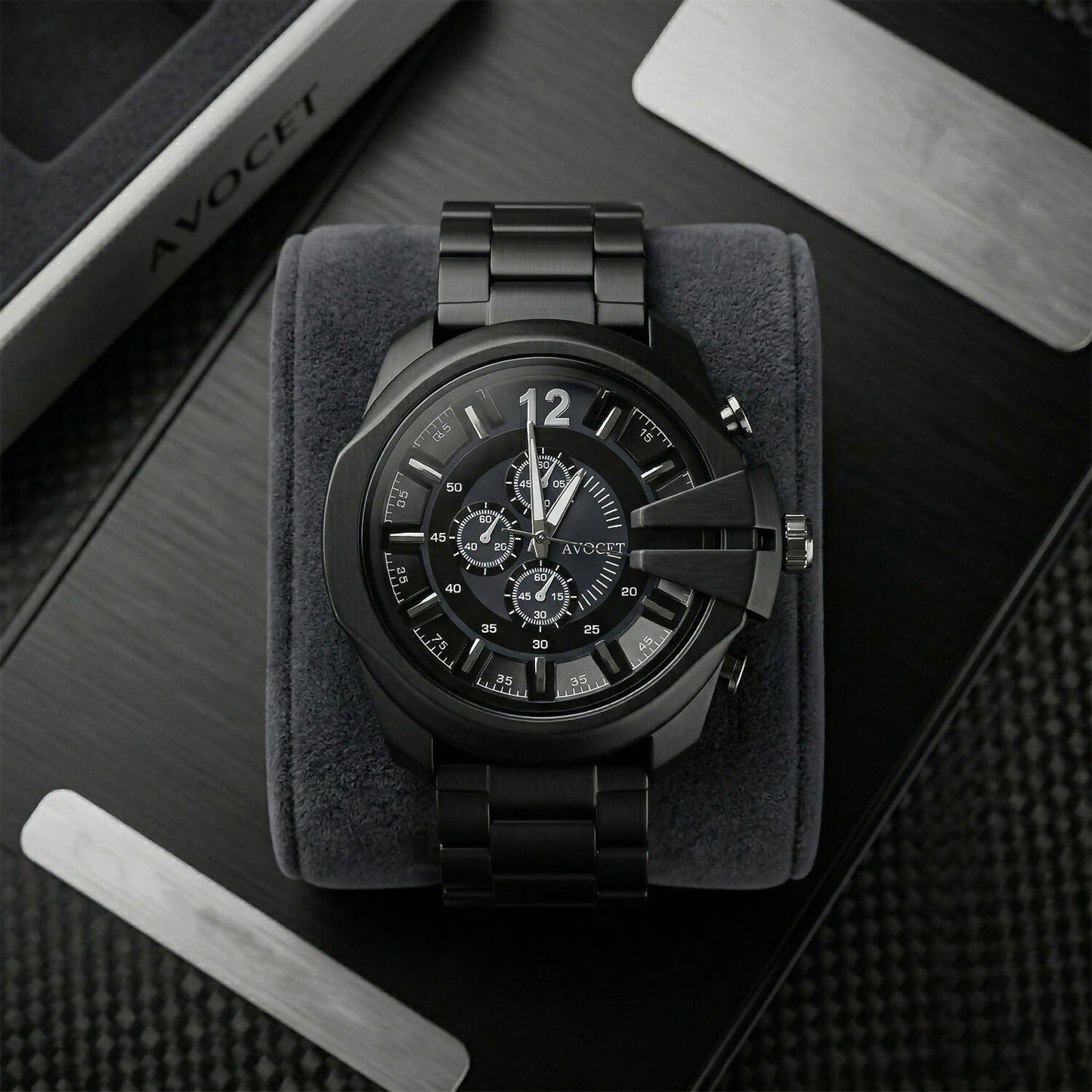 Black chronograph wrist watch on wooden surface