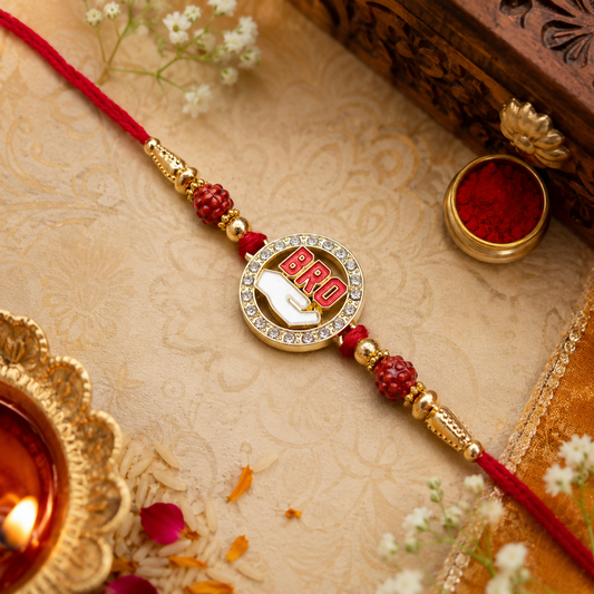 A red thread bracelet with a golden circular charm featuring "BRO" in red, surrounded by rhinestones, on a festive