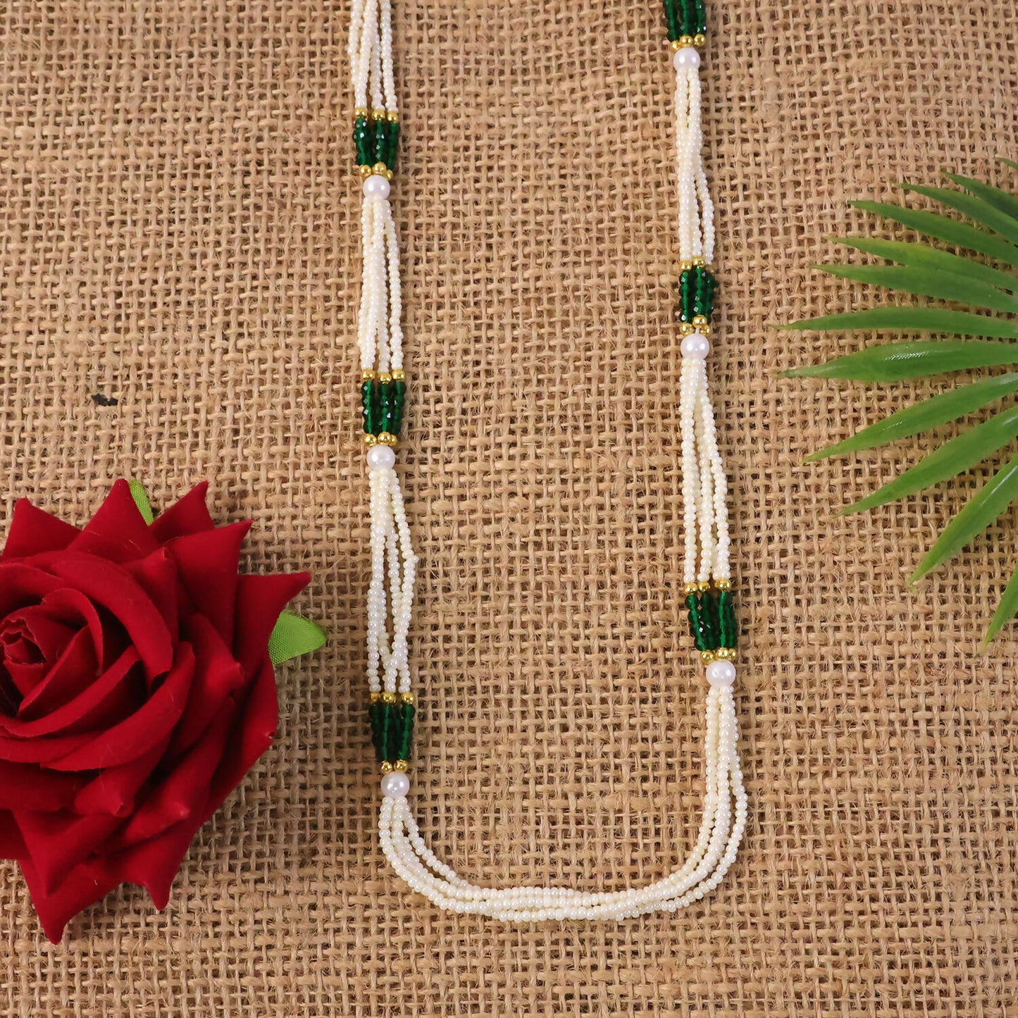 Gold-toned accents on pearl mala necklace with green beads