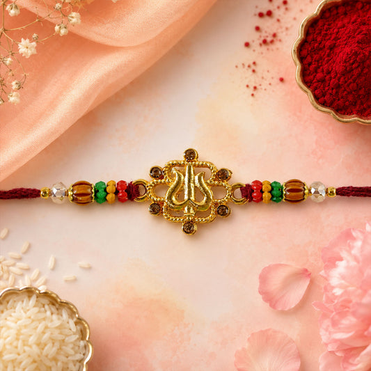 Close-up view of the Tilak Trishul Devotional Rakhi with its golden centre and wooden beads.