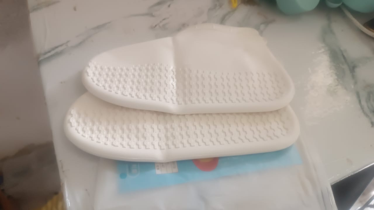 Person wearing silicone shoe covers while walking outdoors