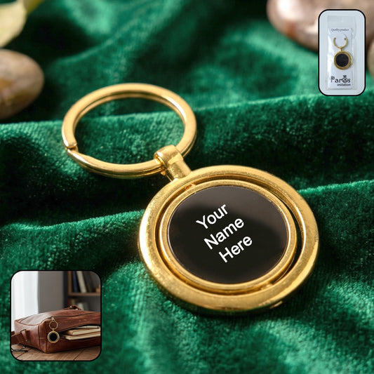 Elegant gold plated keychain with a black round rotating pendant, showcasing its premium finish.