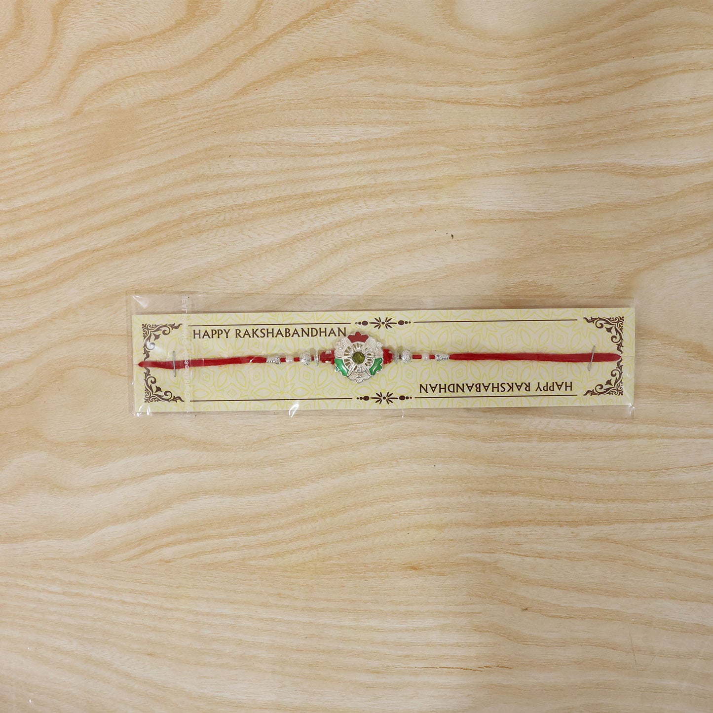 Green White Flower Rakhi with Silver Beads and Red Thread