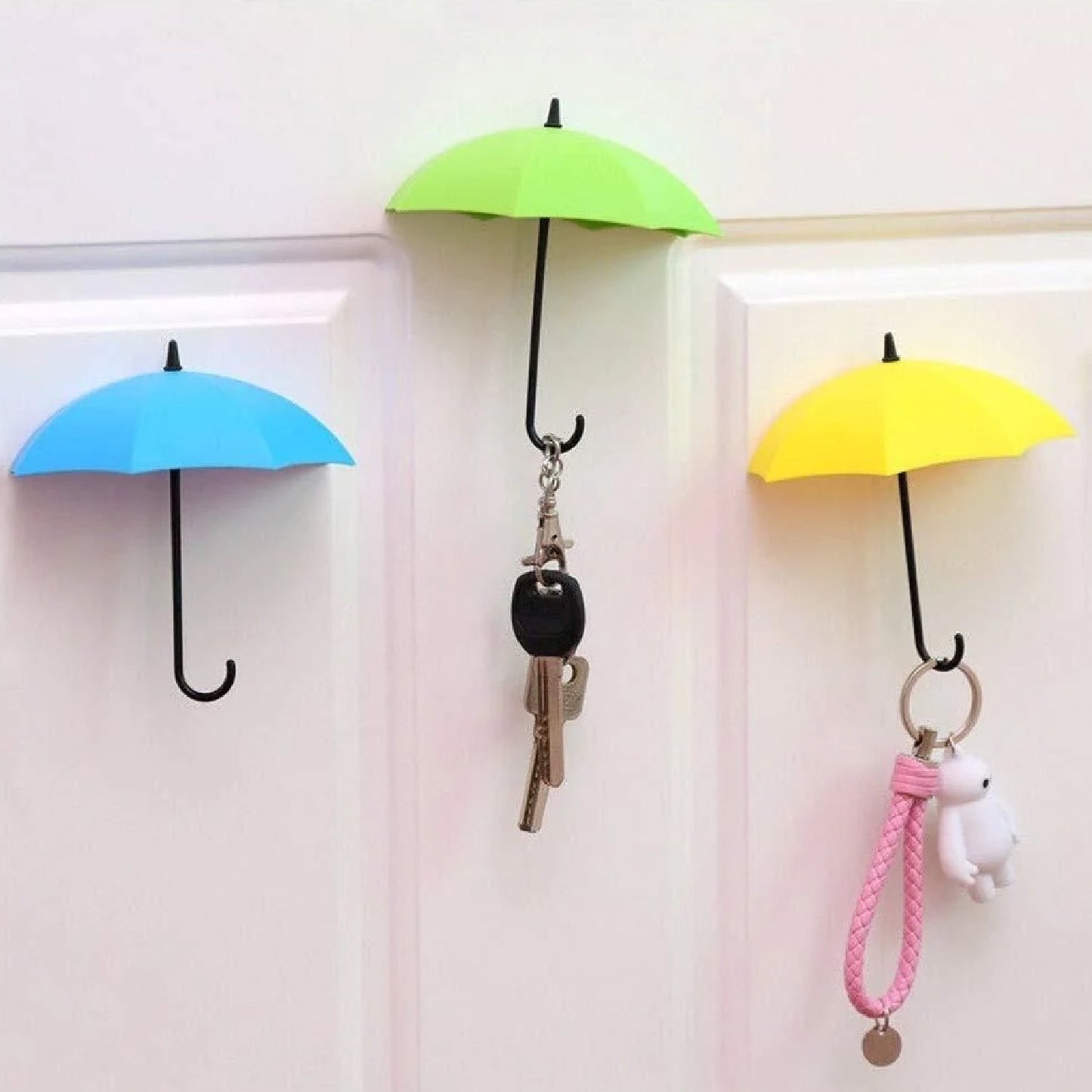 Multicolor umbrella-shaped wall hook holding keys and hats