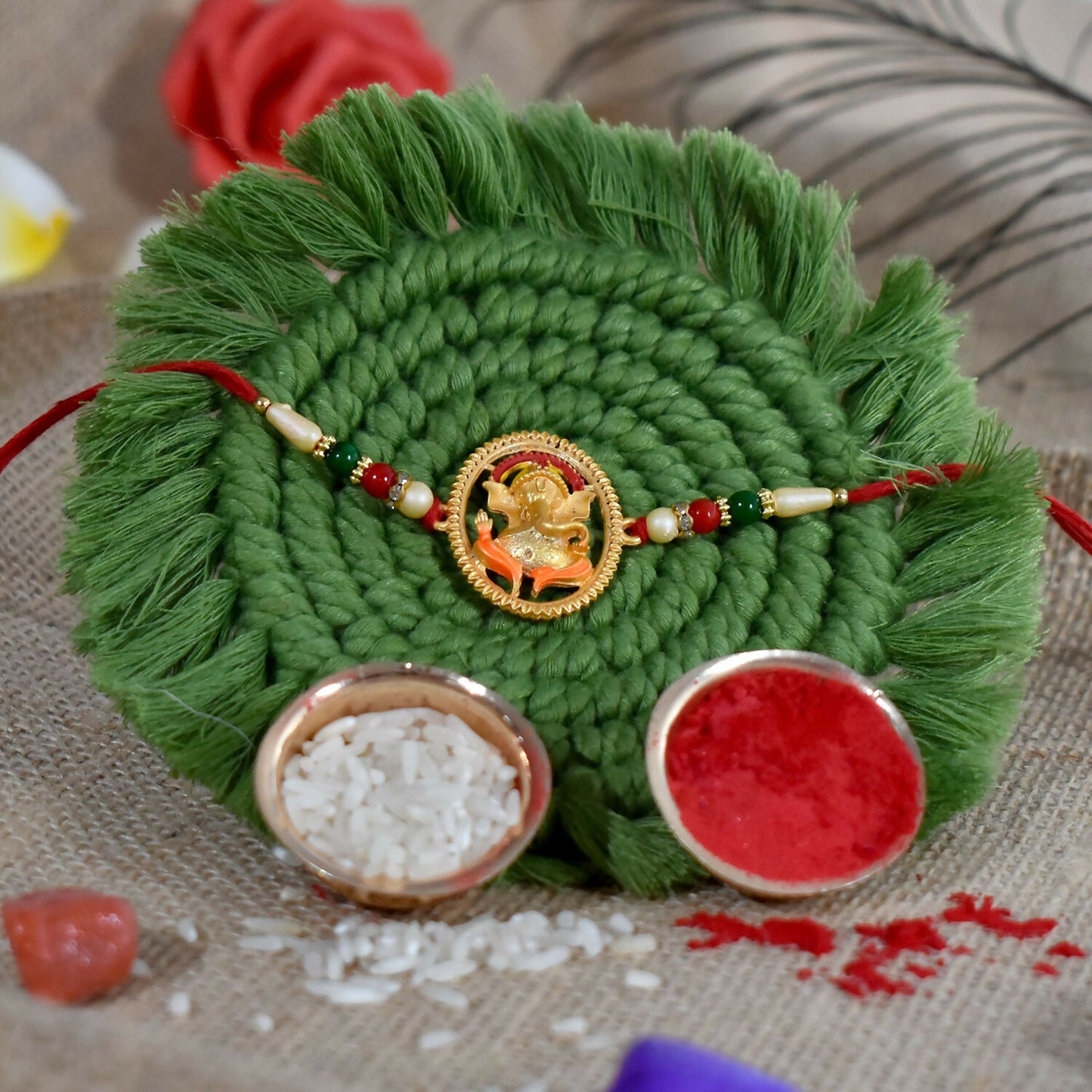 Handcrafted Ganesha rakhi with detailed motif and bright bead decorations