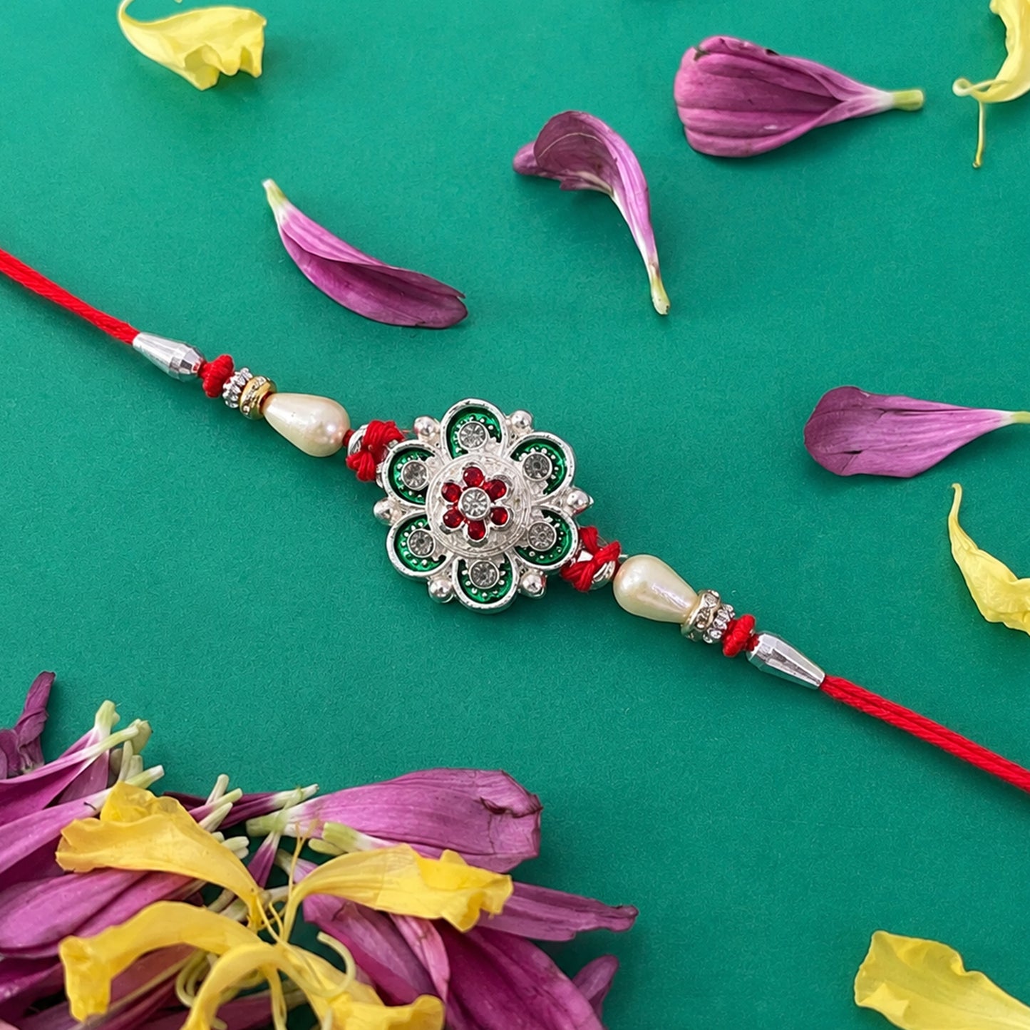 Green Flower Rakhi with Red Beads and Pearl Thread Styling