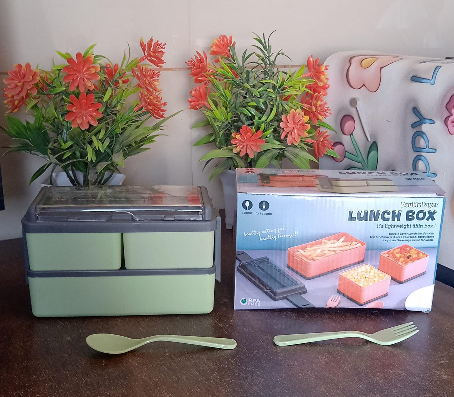 Woman thoughtfully packing a balanced, healthy meal into the 3-compartment leak-proof lunch box.