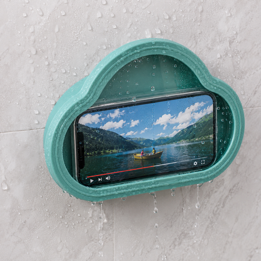 A teal cloud-shaped waterproof phone holder with a phone playing a video, mounted on a wet white tiled wall.