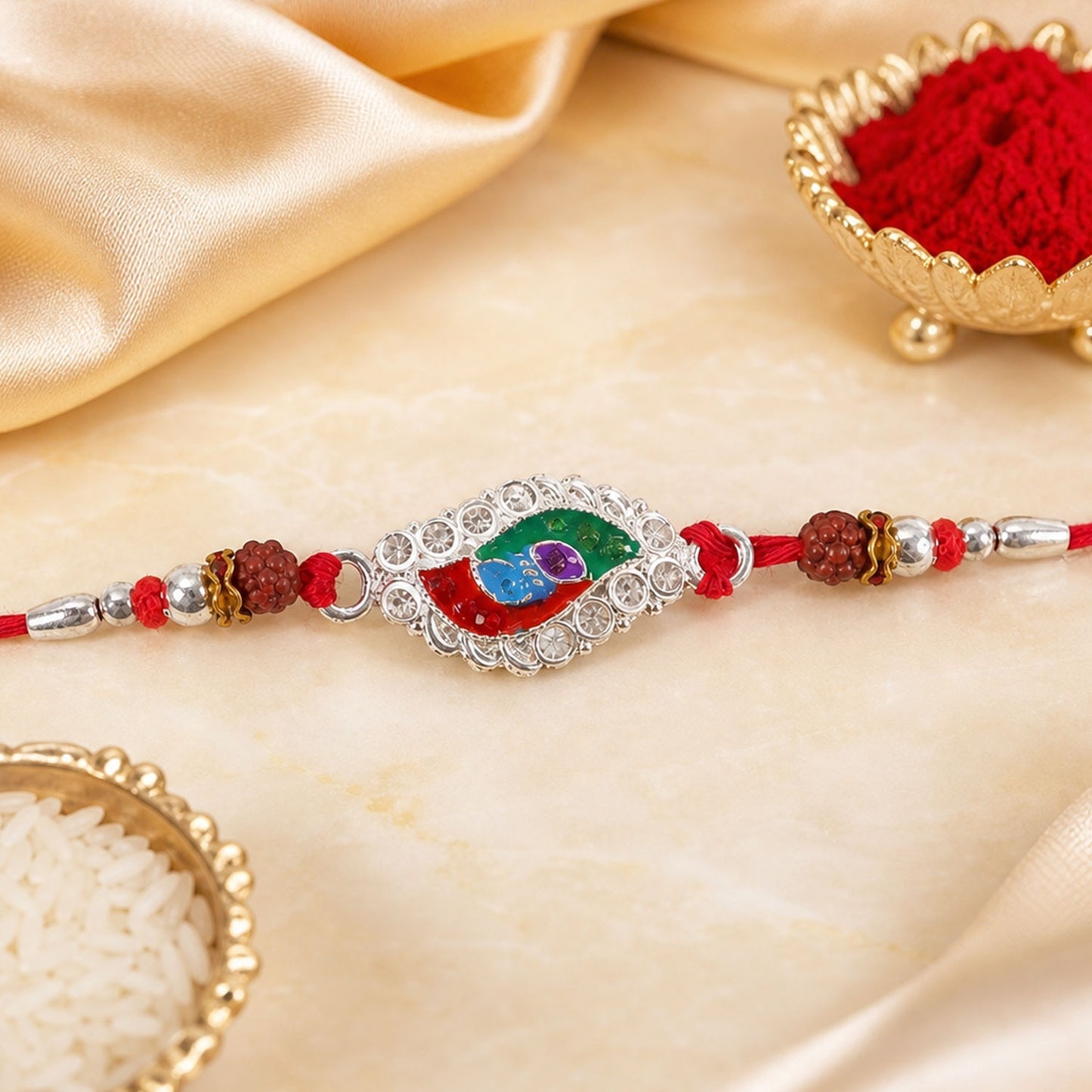 Silver Meenakari Marquise Rakhi with Rudraksha beads, ideal for Raksha Bandhan.