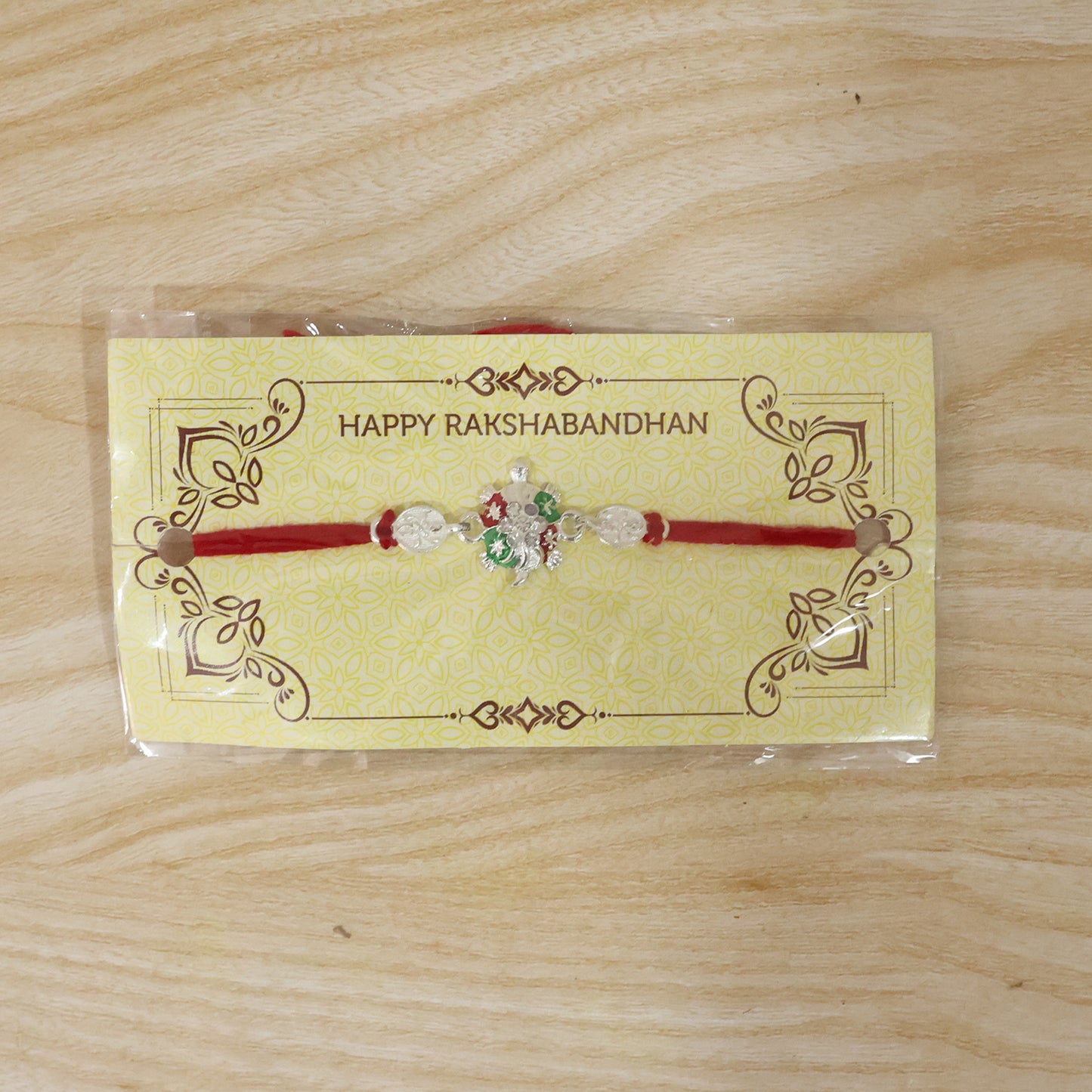 Turtle Rakhi with Red Thread and Crystal Embellishments
