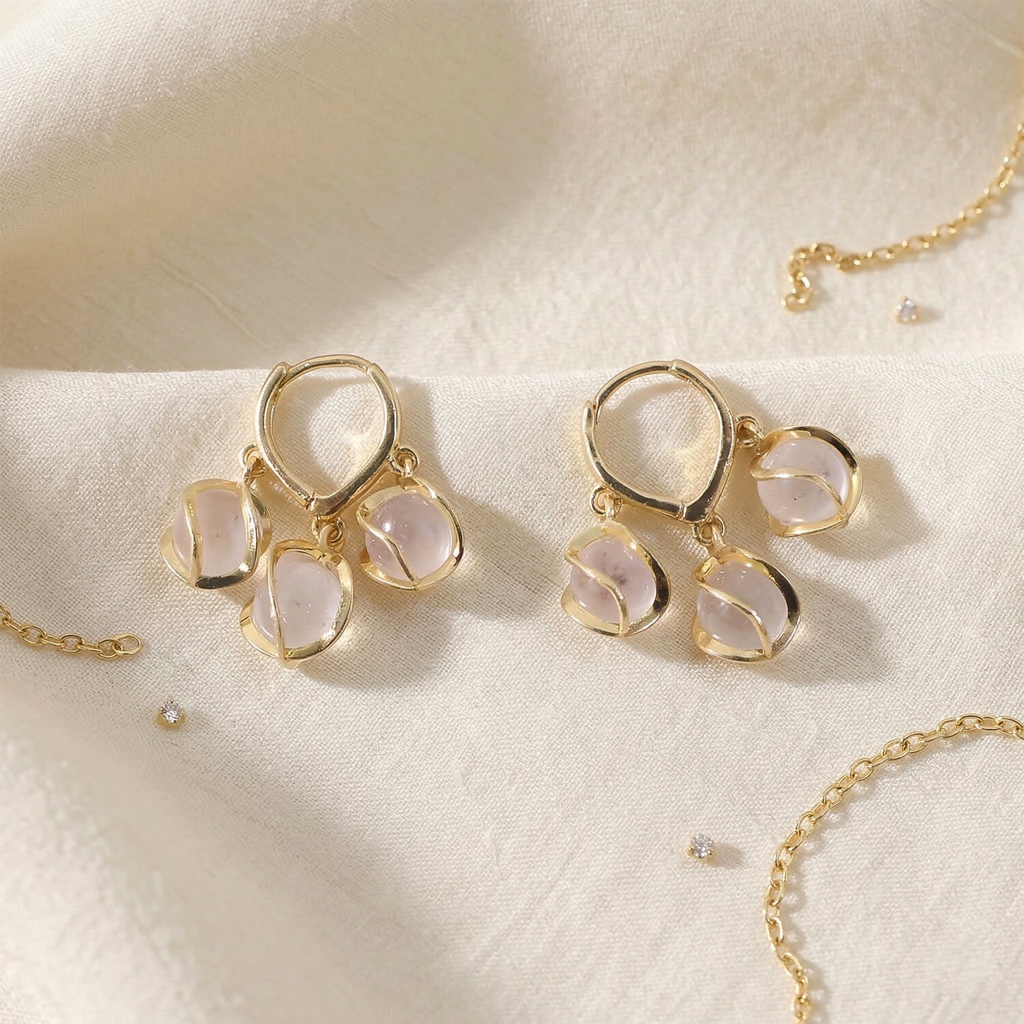 Gold hooped earrings with shimmering opal stones