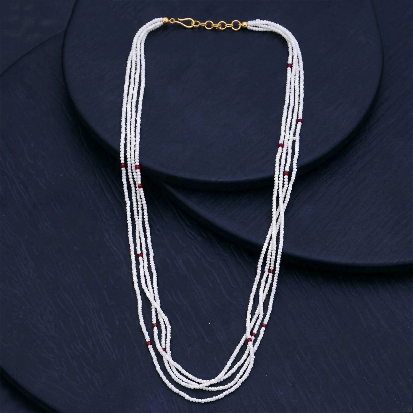 Multi-layer white mala necklace draped gracefully