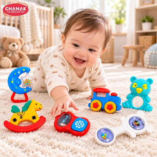 A smiling baby crawls on a beige rug surrounded by six colorful plastic rattles, reaching for one.