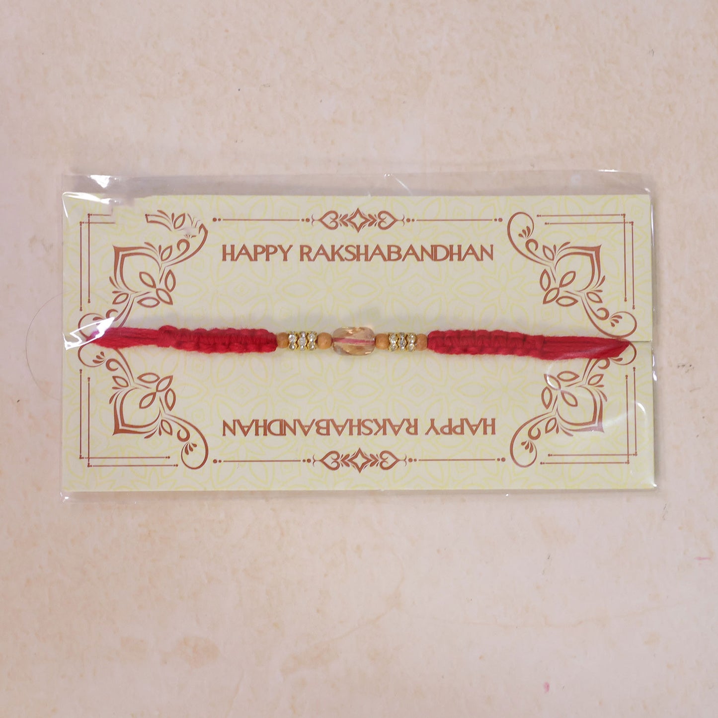 Red Thread Rakhi with Wooden Beads and a Sparkling Crystal Accent