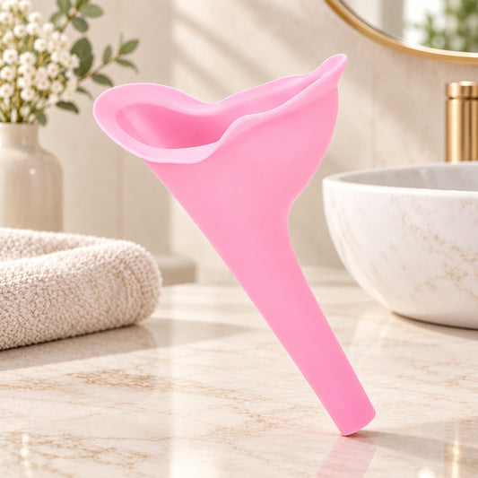 A pink silicone female urination funnel stands upright on a marble countertop in a bathroom setting.