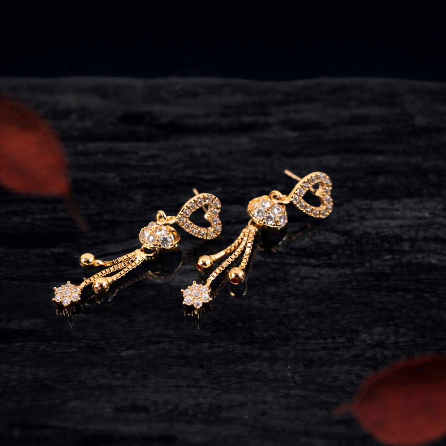 Close-up of rose gold crystal heart tassel earrings showing intricate detailing
