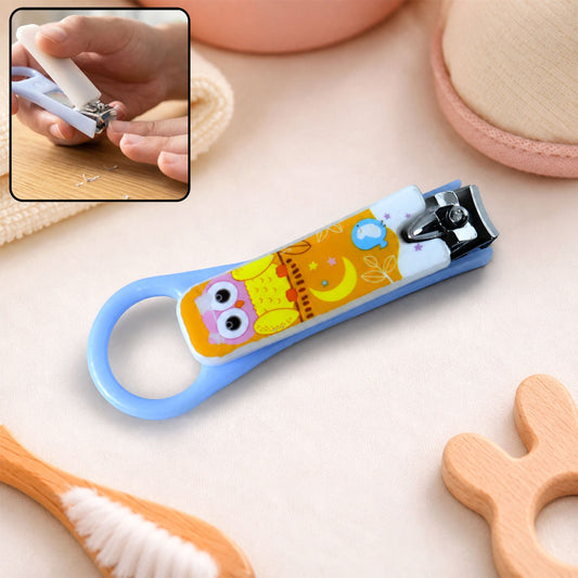 A light blue baby nail clipper with a yellow and white owl design, shown with an inset of it being used.