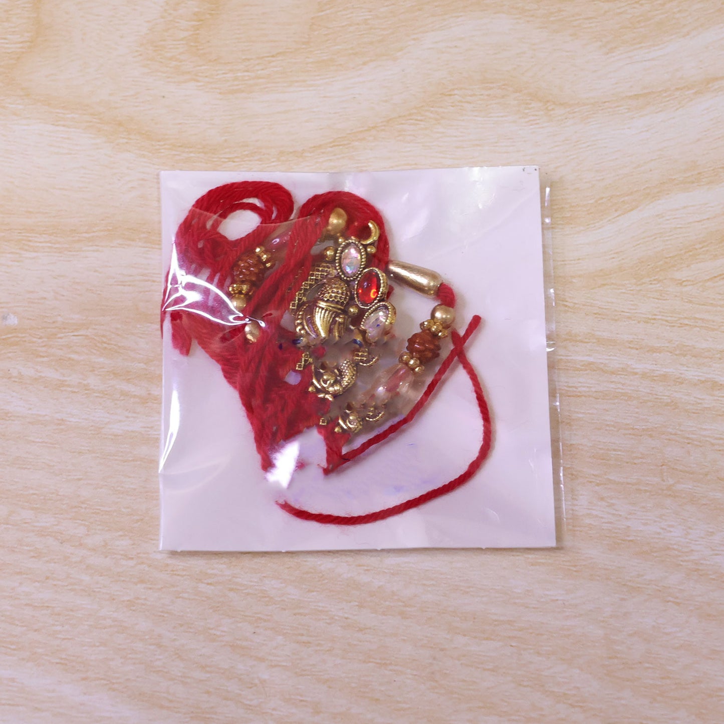 Elegant Rakhi with Ornate Floral Medallion and metal trims in chain look for Gift Use