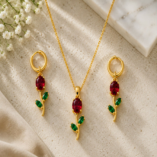 Close-up of the ruby red crystal floral pendant necklace and its elegant green leaf design.