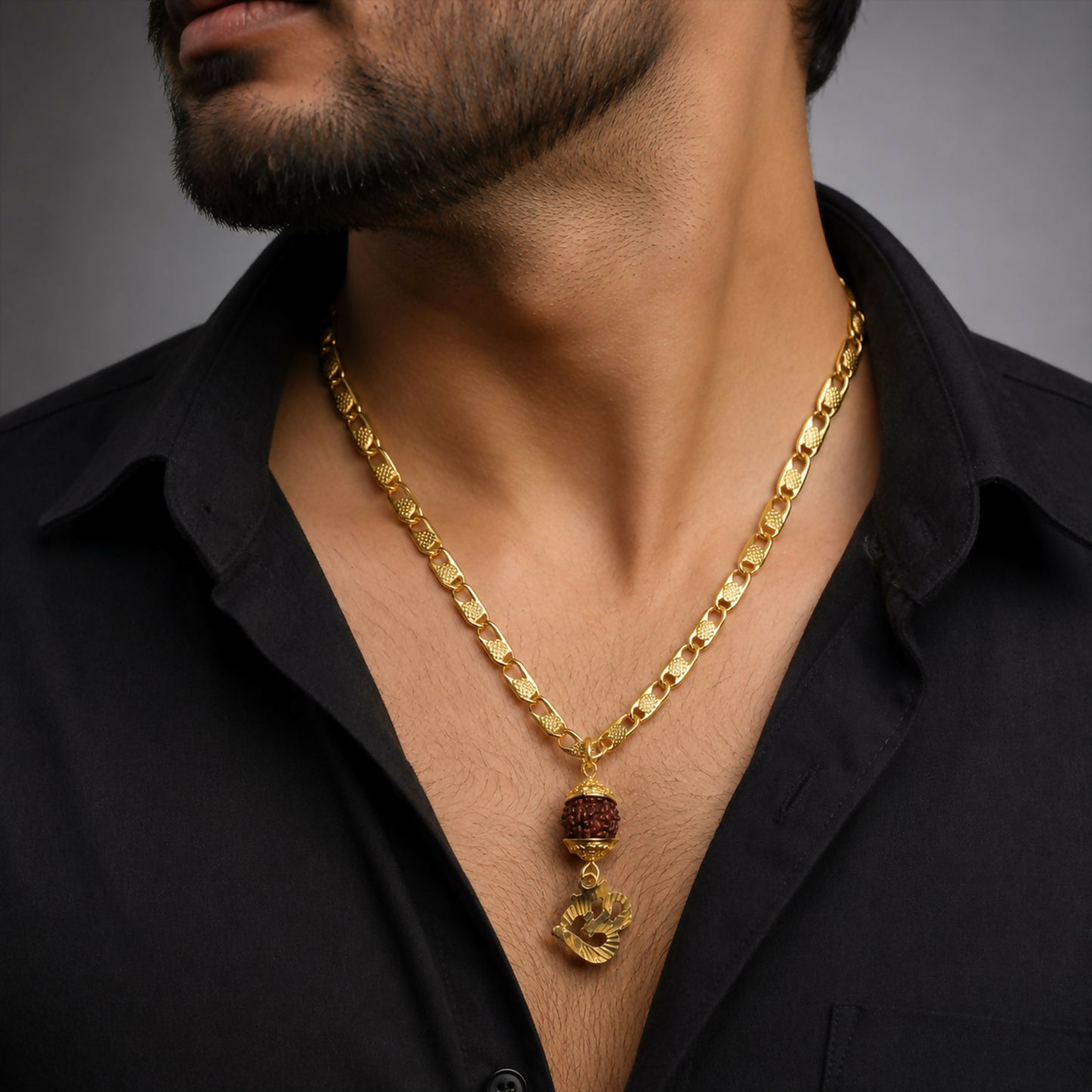 Close-up of Rudraksha bead and Om charm on gold finish pendant chain