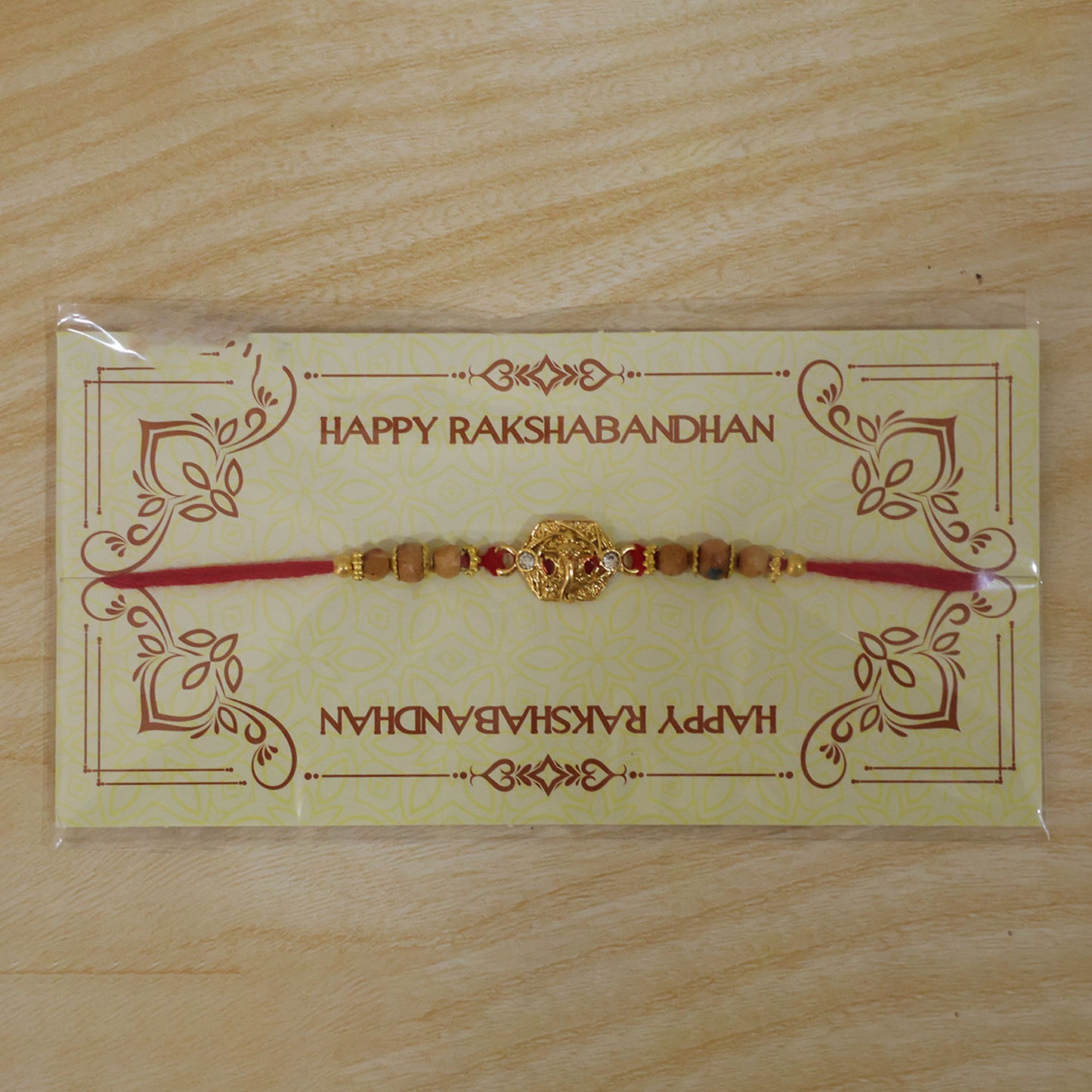 Ganesh Temple Devotional Rakhi with Golden Centre, Wooden Beads and Red Thread
