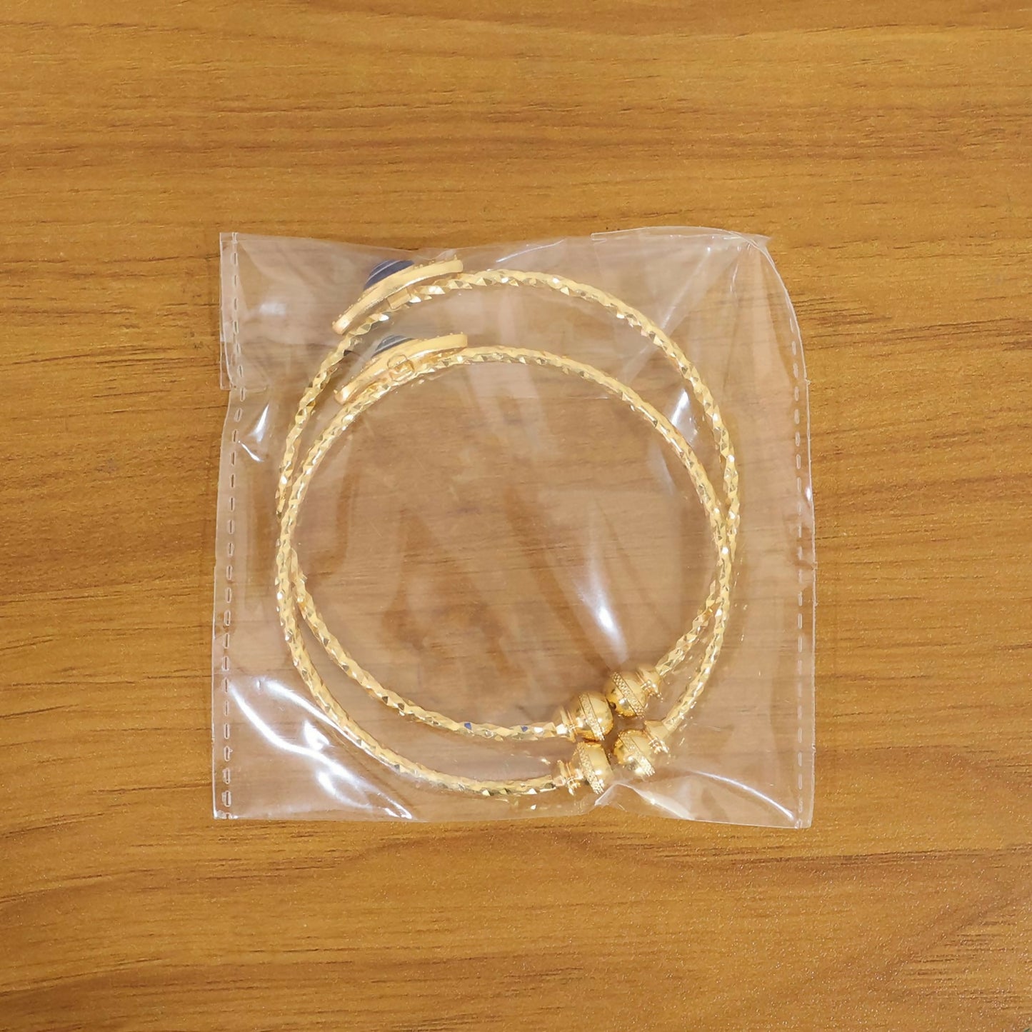 Elegant gold evil eye bangles with blue eye detail arranged artistically