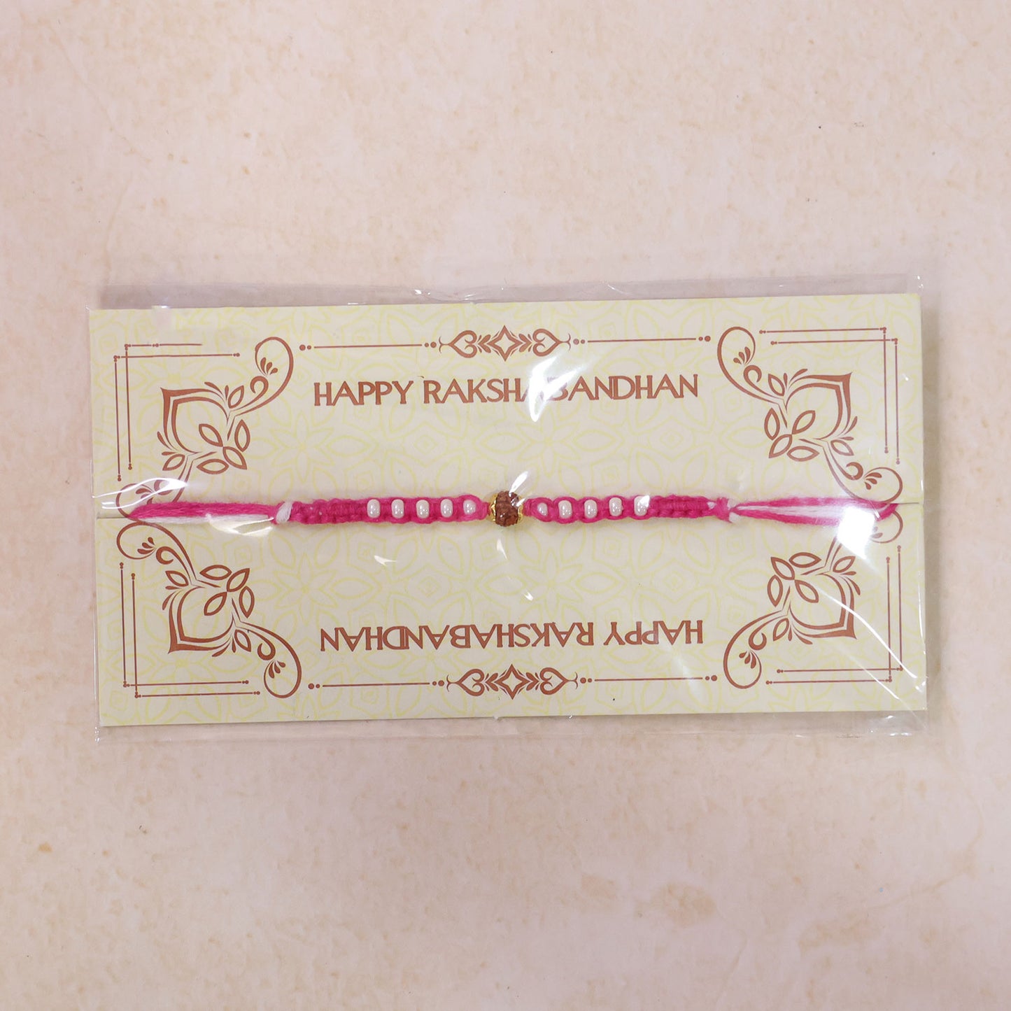Pink-White Braided Rakhi with Natural Rudraksha Bead Pendant