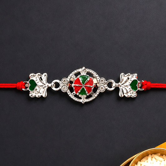 Silver Floral Rakhi with soft red thread, perfect for Raksha Bandhan.