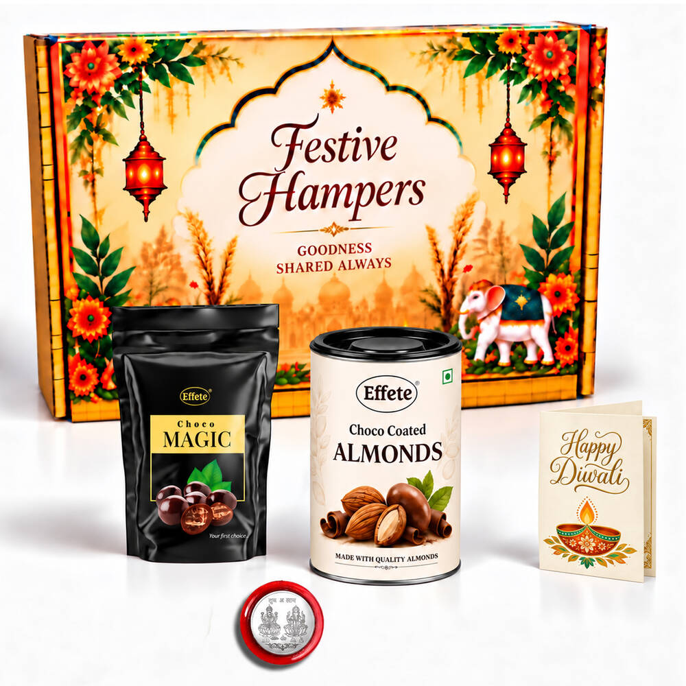 A festive hamper box with a black pouch of Choco Magic, a tin of Choco Coated Almonds, a silver coin, and a greeting card.