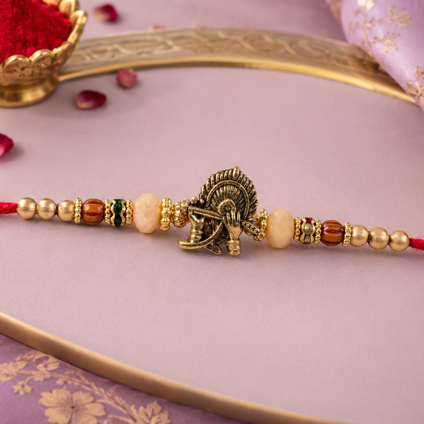 Krishna Flute Peacock Devotional Rakhi with Antique Gold Centre and Peach Beads