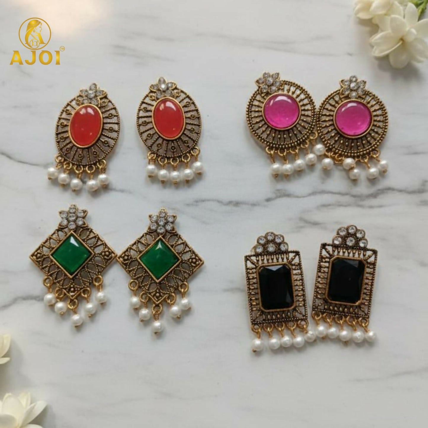 Four designer pairs of antique gold-finish earrings with pearl drops