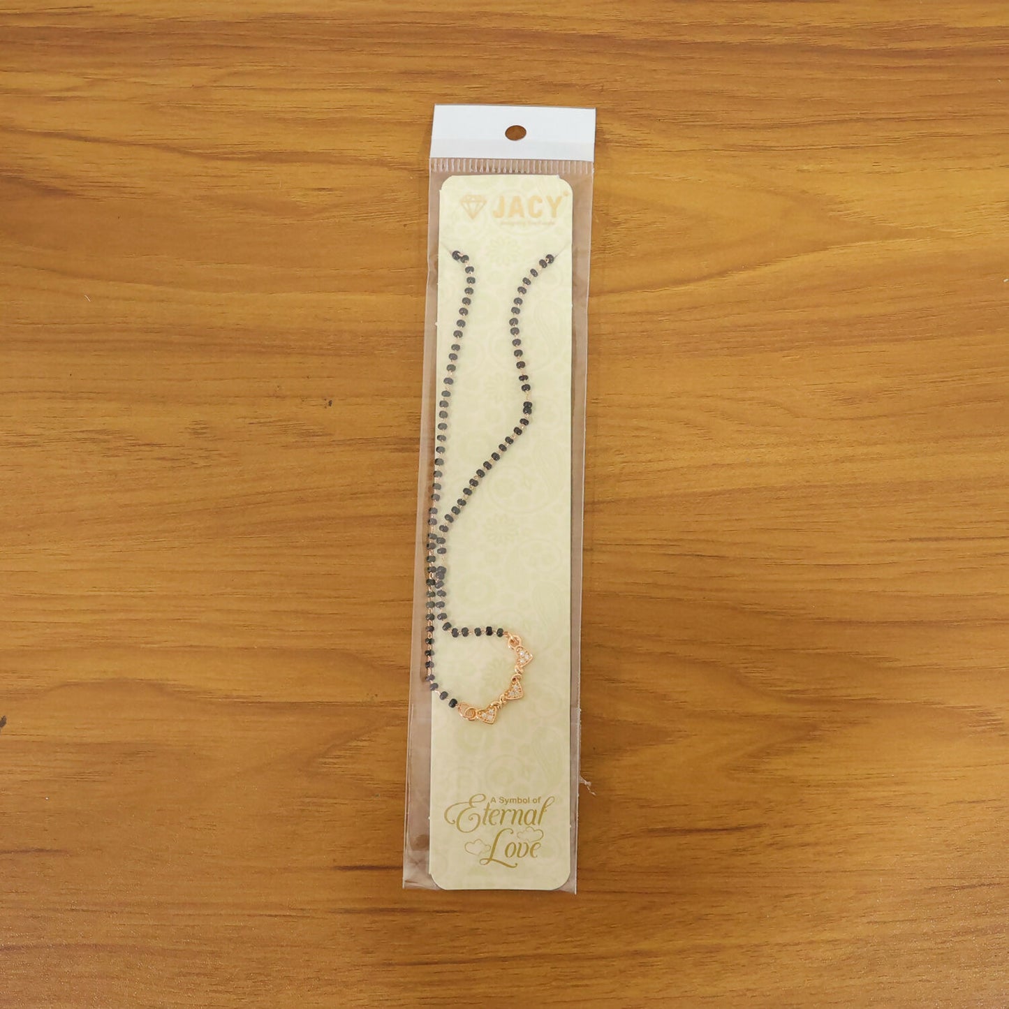 Close-up of the stylish mangalsutra pendant with crystals and black beads.