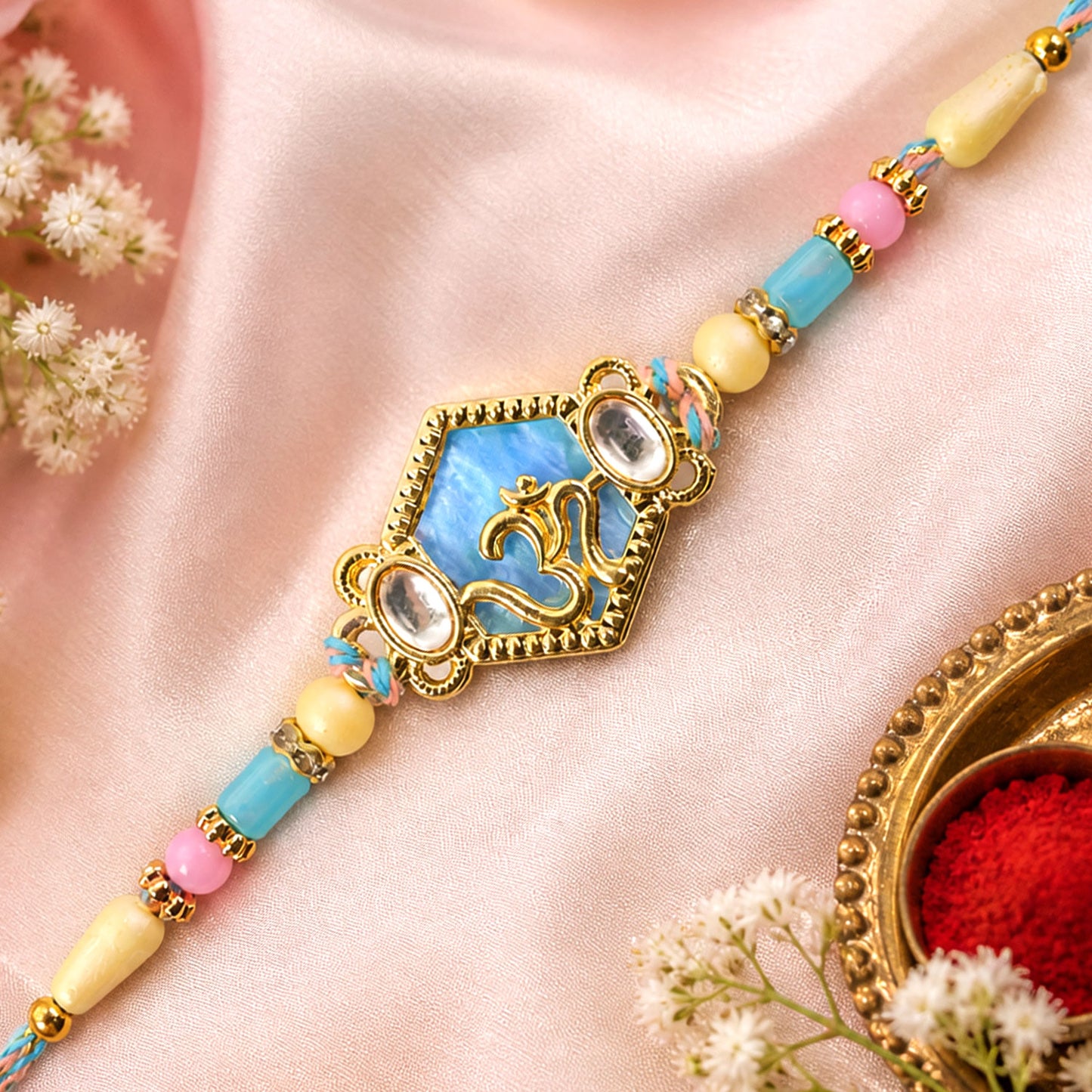 Om Hexagon Pendant Rakhi with Blue Enamel and Kundan Stones