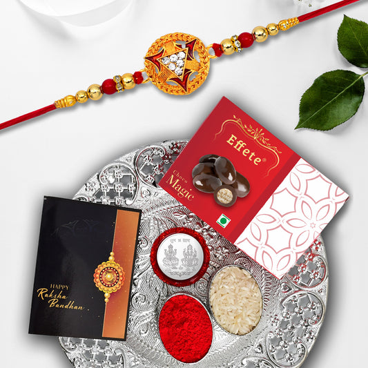 Golden designer rakhi combo set including rakhi, chocolate, and greeting card
