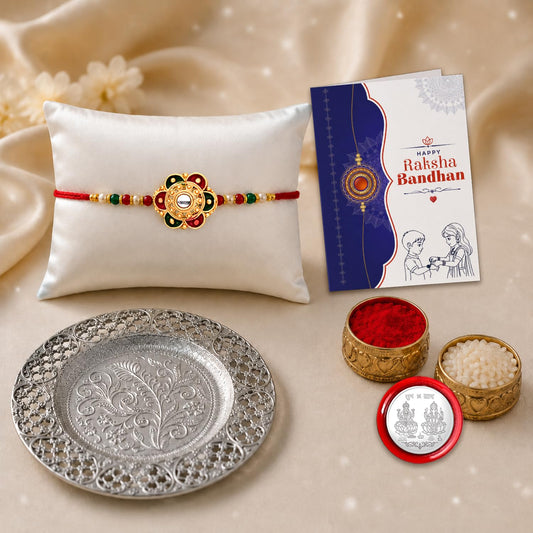 Multicolor flower rakhi and silver pooja thali gift hamper for Raksha Bandhan celebration.