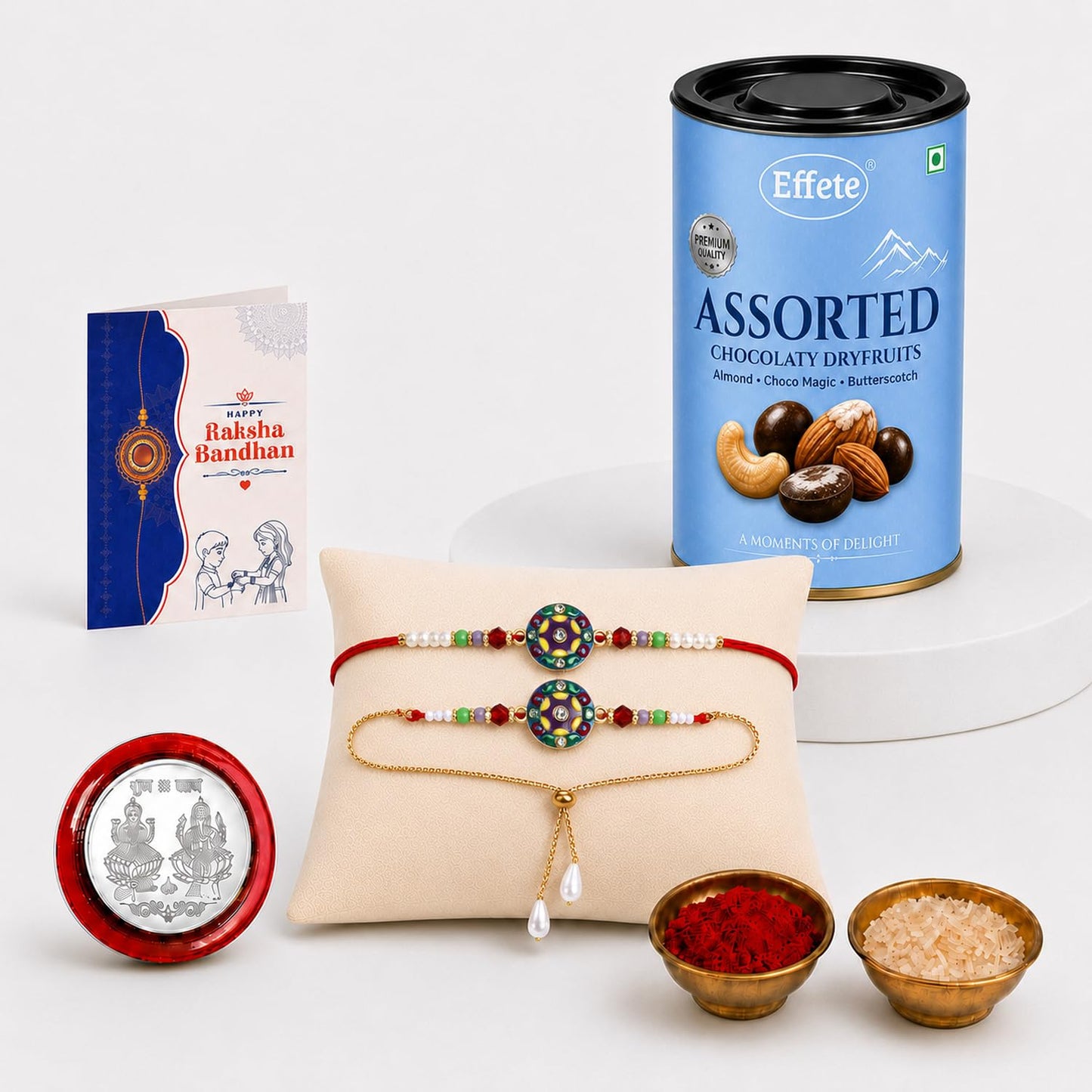 A blue can of assorted dry fruits, two bracelets on a pillow, a greeting card, a silver coin, and two small bowls of powder.