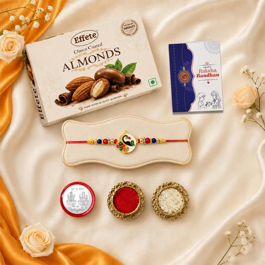 Raksha Bandhan Gift Combo featuring a peacock rakhi, chocolate almonds, roli chawal, and a pooja coin.