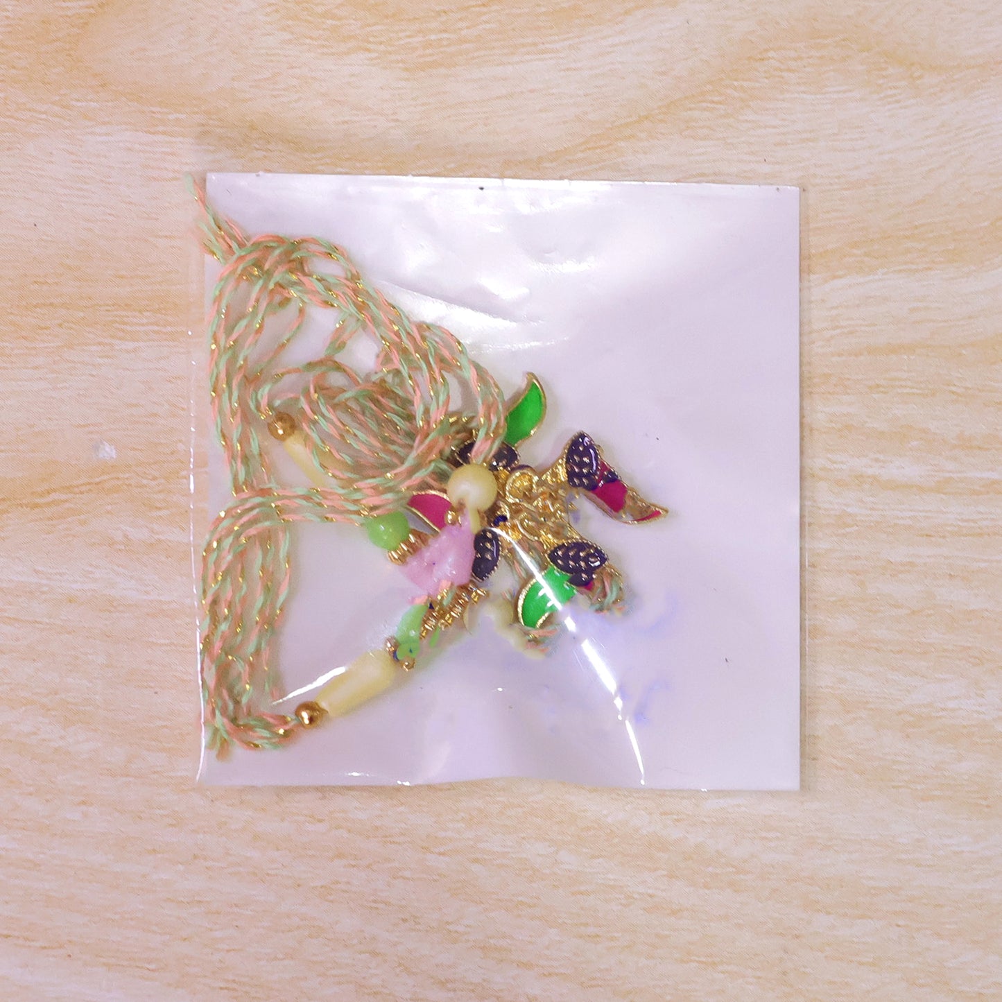 Ornate Rakhi with Butterfly Flower Charm and pearl accents in bead line for Gift Use